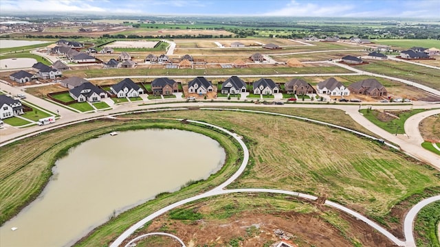 drone / aerial view with a residential view and a water view