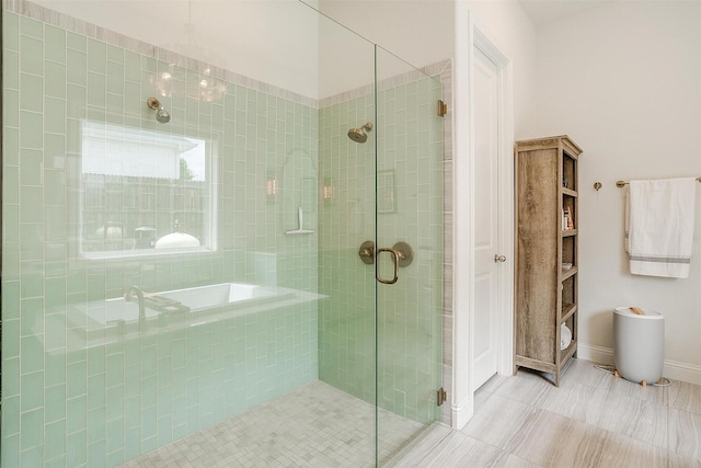 bathroom with a shower stall, tile patterned flooring, and a garden tub