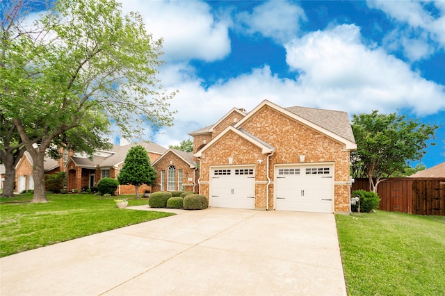 view of front facade featuring fence, brick siding, driveway, a garage, and a front yard