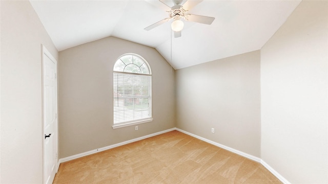 unfurnished room featuring light colored carpet, baseboards, lofted ceiling, and a ceiling fan