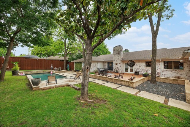 view of swimming pool featuring a lawn, a patio, fence, and a fenced in pool