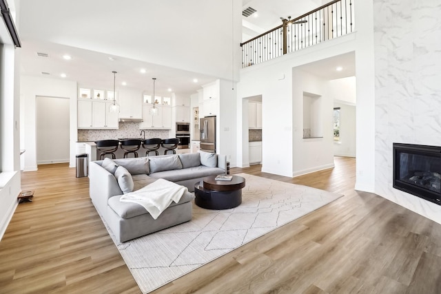 311 Misty Ln, Argyle, TX 76226 - living area with recessed lighting, visible vents, light wood-style flooring, and a fireplace