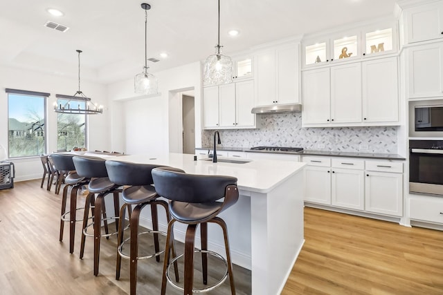 311 Misty Ln, Argyle, TX 76226 - kitchen featuring a sink, light wood-style floors, stainless steel appliances, and visible vents