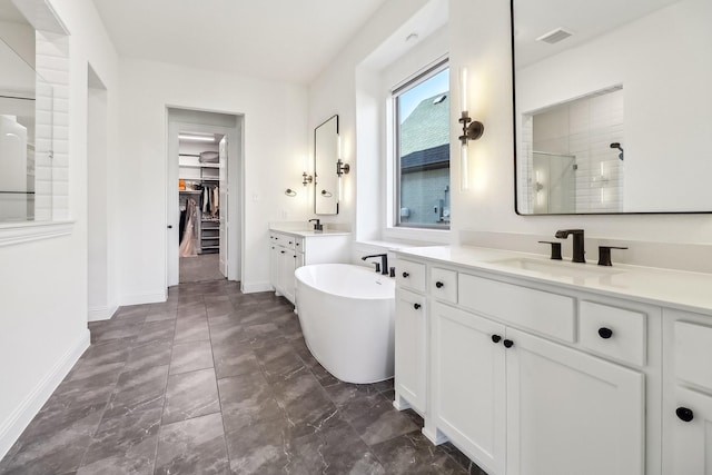 311 Misty Ln, Argyle, TX 76226 - full bath with visible vents, a freestanding tub, baseboards, a shower stall, and a sink