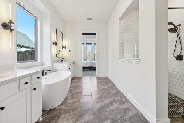 311 Misty Ln, Argyle, TX 76226 - ensuite bathroom featuring visible vents, a soaking tub, a sink, ensuite bath, and a tile shower