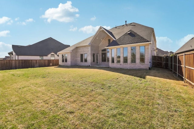 311 Misty Ln, Argyle, TX 76226 - back of property featuring a lawn, a fenced backyard, roof with shingles, and brick siding
