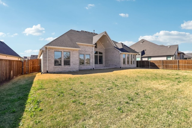 311 Misty Ln, Argyle, TX 76226 - rear view of property featuring brick siding, a fenced backyard, and a lawn