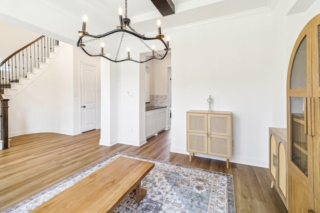 311 Misty Ln, Argyle, TX 76226 - dining area with a notable chandelier, baseboards, wood finished floors, beamed ceiling, and stairway