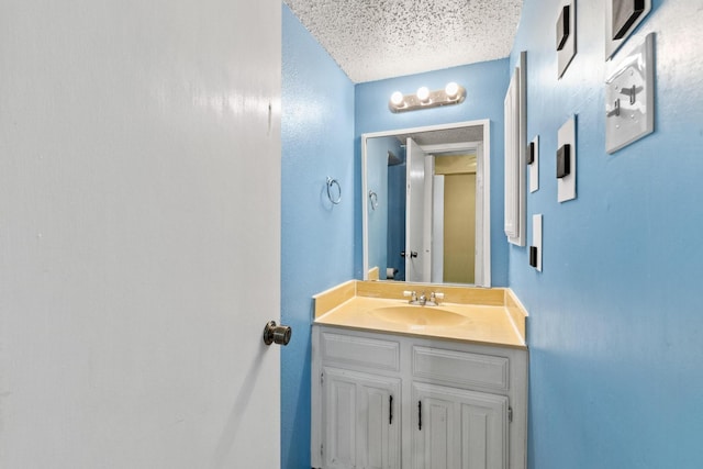 bathroom with vanity and a textured ceiling