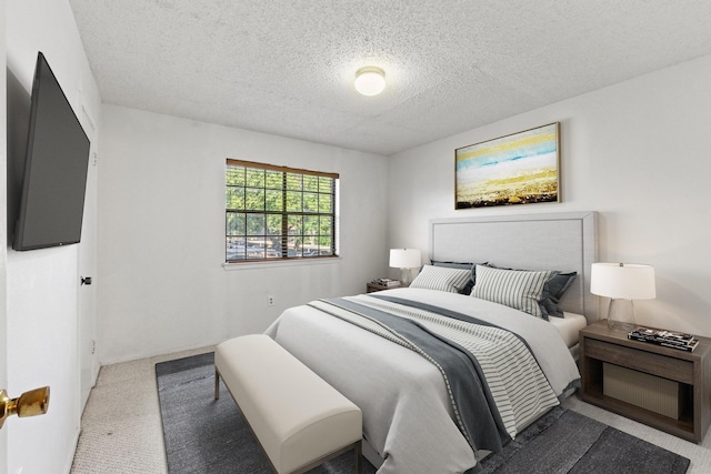 bedroom featuring carpet flooring and a textured ceiling