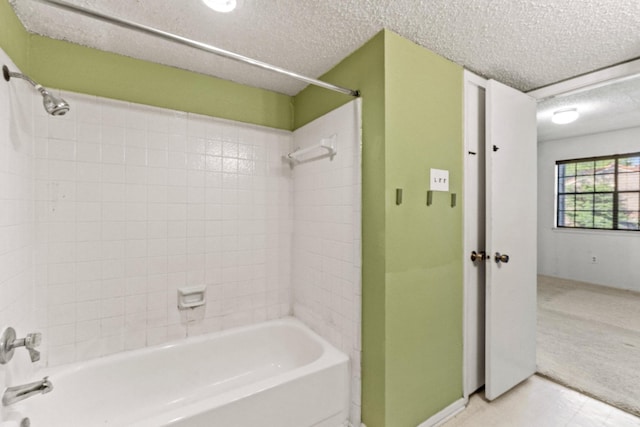 bathroom with baseboards, a textured ceiling, and tub / shower combination