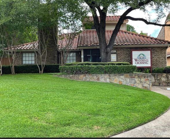mediterranean / spanish-style home with a tiled roof and a front lawn