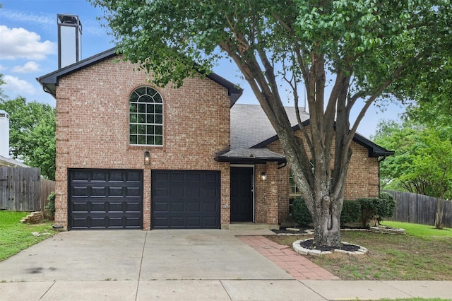 view of front of house featuring fence, an attached garage, driveway, and brick siding
