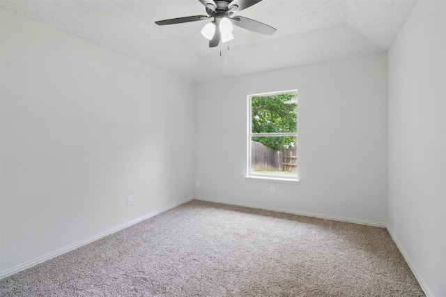 spare room featuring baseboards, a ceiling fan, carpet, and a textured ceiling