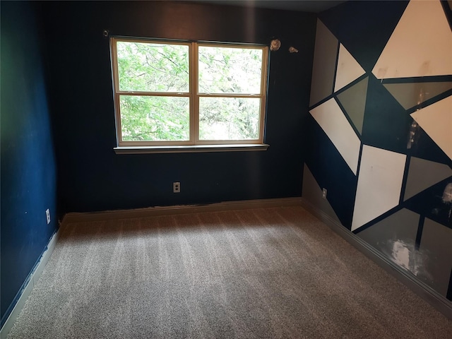 unfurnished room featuring baseboards, plenty of natural light, and carpet