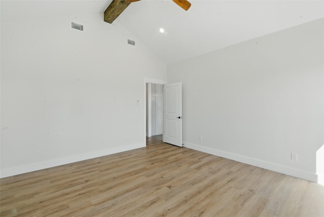 unfurnished room featuring beamed ceiling, visible vents, light wood finished floors, and high vaulted ceiling