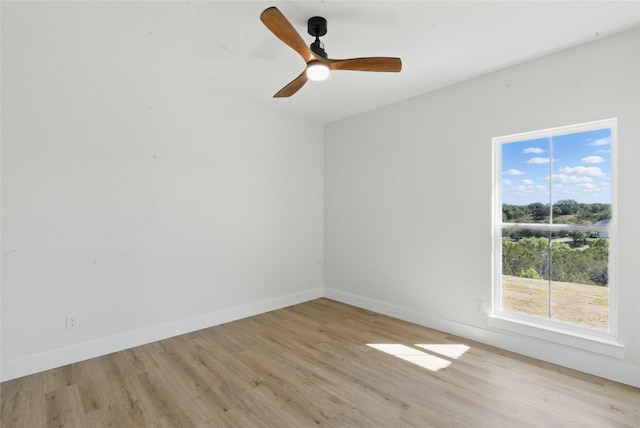 unfurnished room with light wood-style floors, baseboards, and ceiling fan