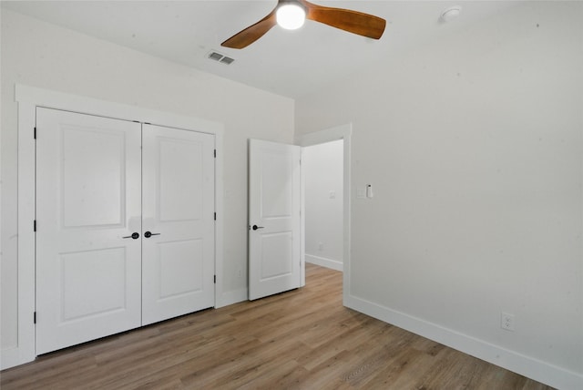 unfurnished bedroom with a ceiling fan, visible vents, baseboards, a closet, and light wood-style floors