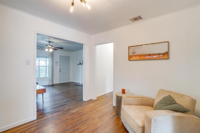 sitting room featuring baseboards, visible vents, and wood finished floors