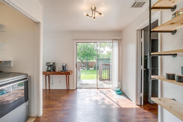 doorway with visible vents and wood finished floors