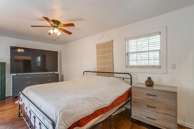 bedroom with ceiling fan and dark wood-type flooring