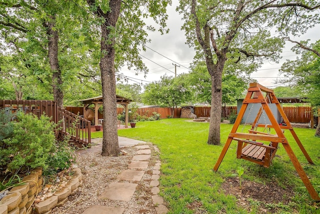 view of yard featuring a playground, a gazebo, and a fenced backyard