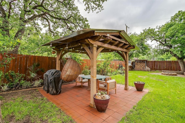 view of patio with a gazebo, a fenced backyard, and an outdoor fire pit