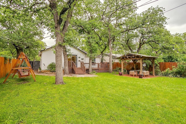 view of yard featuring a deck, a gazebo, an outdoor living space, and a fenced backyard