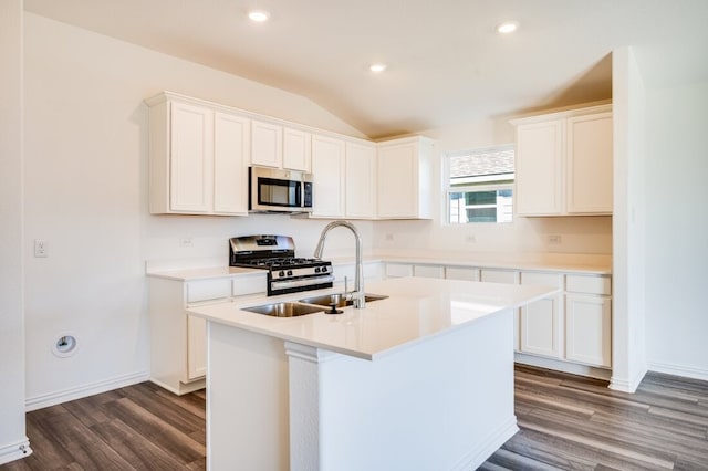 kitchen featuring dark wood finished floors, white cabinets, vaulted ceiling, and stainless steel appliances