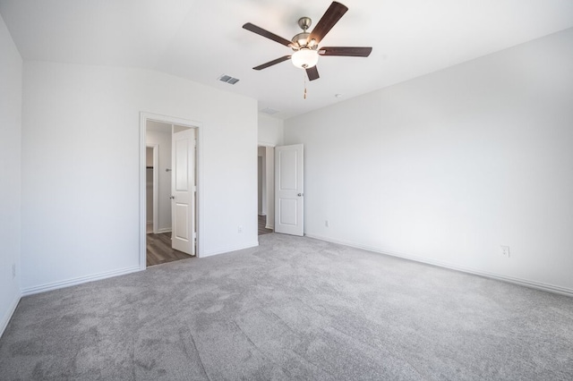 unfurnished bedroom with carpet flooring, ceiling fan, baseboards, ensuite bathroom, and visible vents