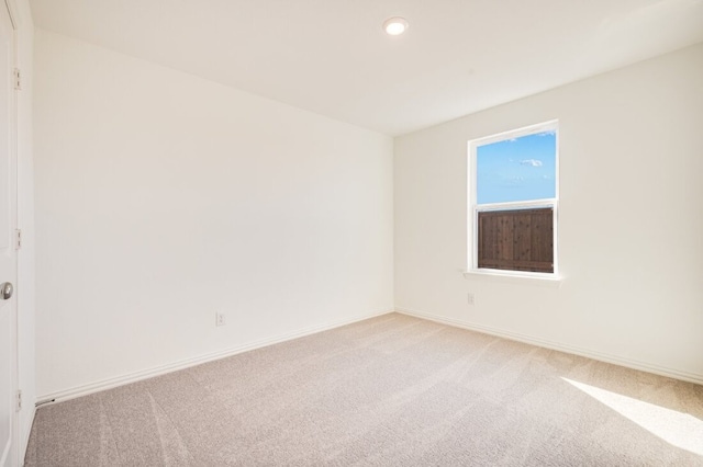 unfurnished room featuring light colored carpet, recessed lighting, and baseboards