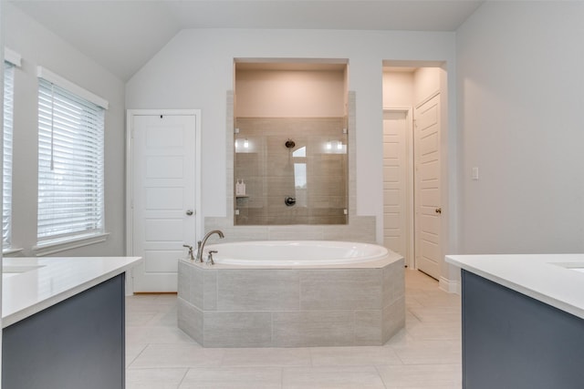 bathroom featuring vanity, tile patterned floors, a garden tub, and a tile shower