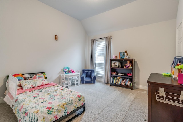 carpeted bedroom featuring baseboards and lofted ceiling