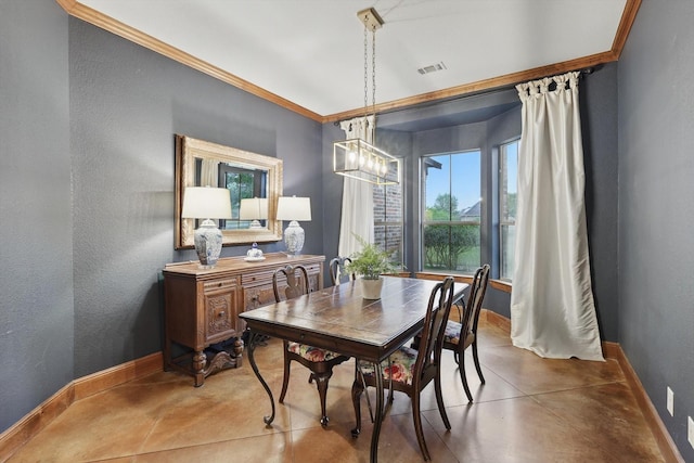dining space featuring crown molding, baseboards, visible vents, and finished concrete floors