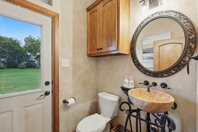 half bath featuring a sink and toilet