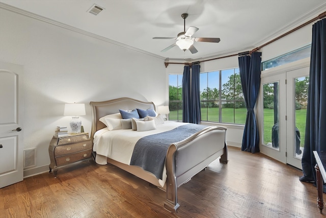 bedroom featuring crown molding, access to exterior, wood finished floors, and visible vents