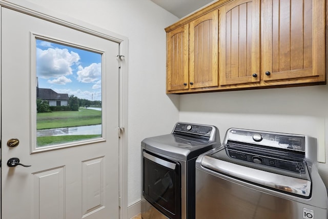 clothes washing area with cabinet space and washing machine and clothes dryer