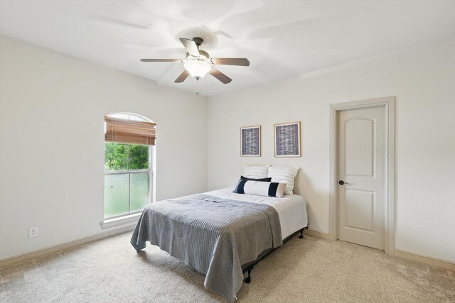 bedroom featuring carpet floors, a ceiling fan, and baseboards