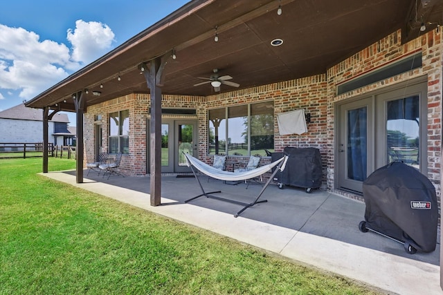 view of patio / terrace featuring ceiling fan, fence, french doors, and a grill