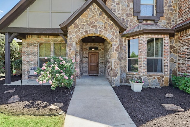 doorway to property with brick siding and stone siding