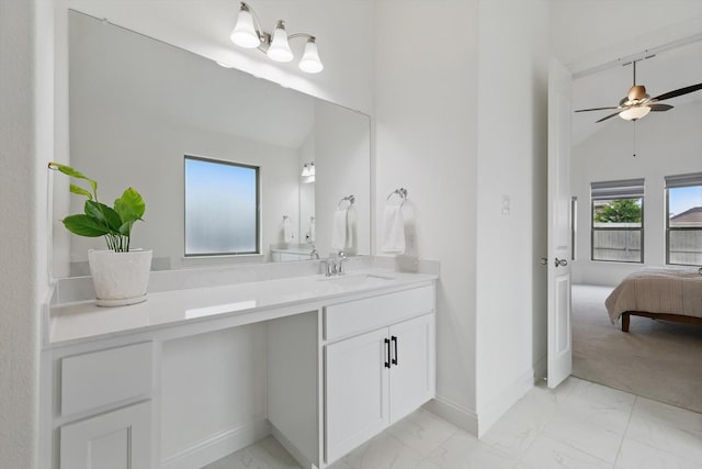 ensuite bathroom featuring vanity, marble finish floor, a ceiling fan, baseboards, and ensuite bathroom
