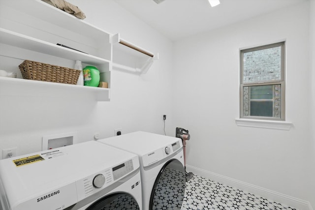 washroom featuring washing machine and clothes dryer, laundry area, baseboards, and tile patterned floors