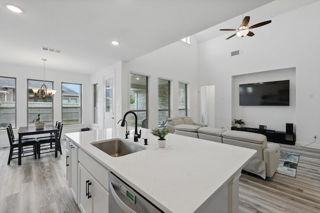 kitchen with dishwasher, visible vents, a sink, and light wood-type flooring