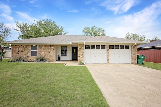 single story home with a shingled roof, an attached garage, a front lawn, brick siding, and driveway