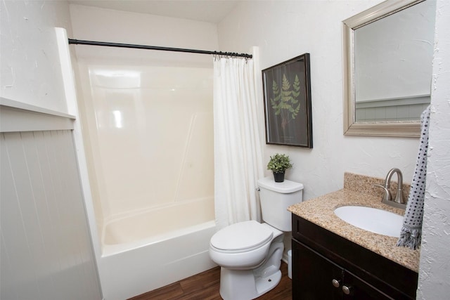 full bathroom featuring vanity, wood finished floors, shower / bath combination with curtain, and toilet