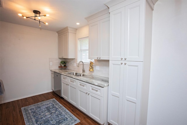 kitchen featuring light stone countertops, a sink, dishwasher, tasteful backsplash, and dark wood-style floors