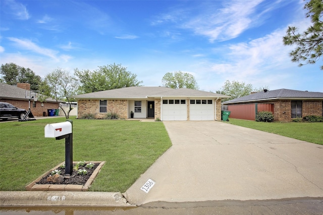 ranch-style home with an attached garage, concrete driveway, brick siding, and a front yard