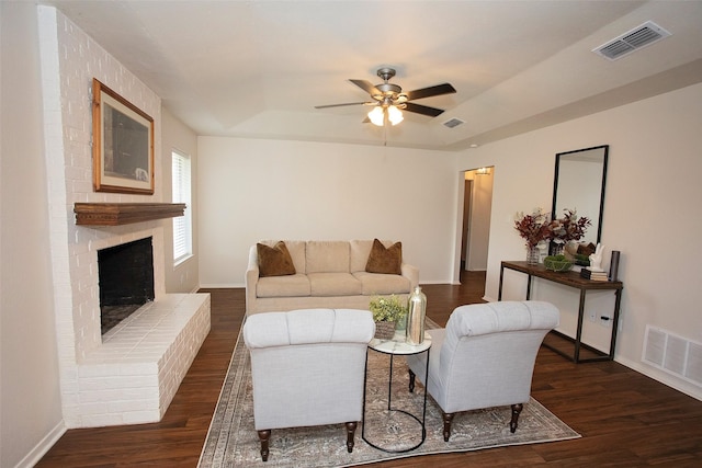 living room with a ceiling fan, wood finished floors, and visible vents