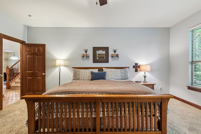 bedroom with baseboards, a ceiling fan, and carpet flooring