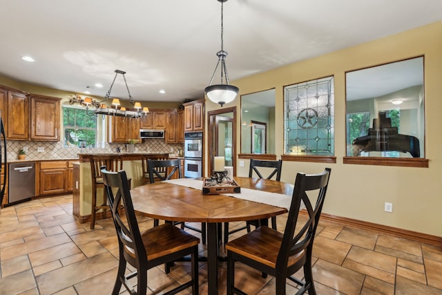 dining room featuring baseboards and recessed lighting